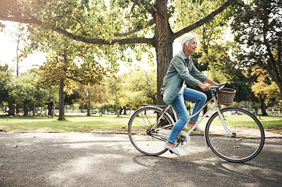 woman riding bike in park 
